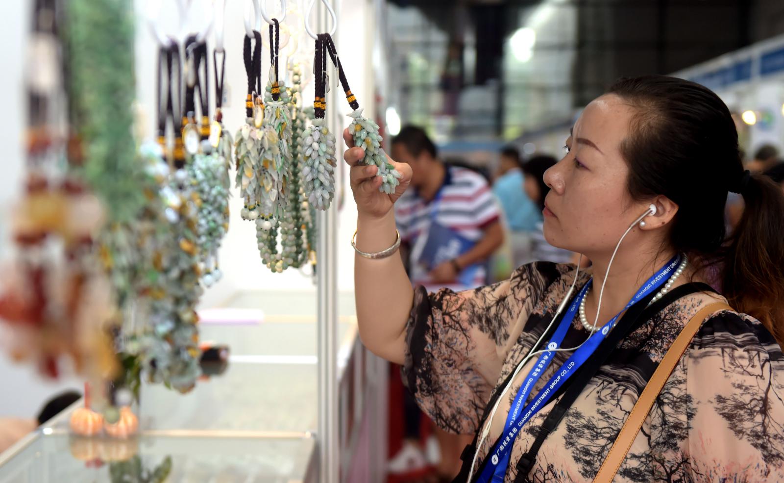 东博会助力缅甸产品走向中国，图为消费者在东博会上挑选缅甸玉器饰品